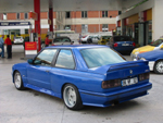 Heckansicht des blauen M3 an der Tankstelle